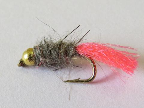 Pink-tag nymph trout fly tied on a hook