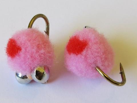 Bright pink hand-tied trout fly with red detail